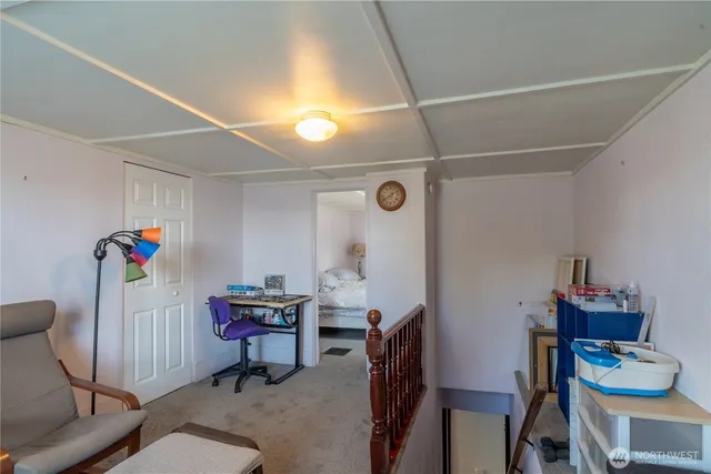 a view of a workspace with furniture and a window