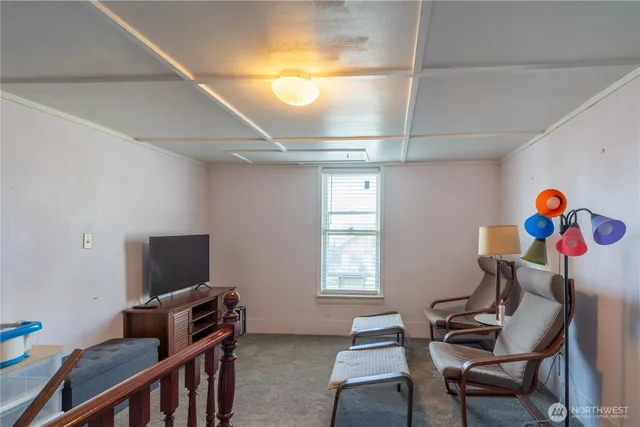 a view of a livingroom with furniture and a window