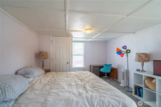 a bedroom with a bed and a book shelf