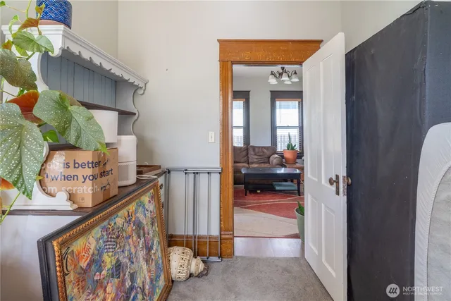 a view of a hallway to a livingroom with furniture and a hallway