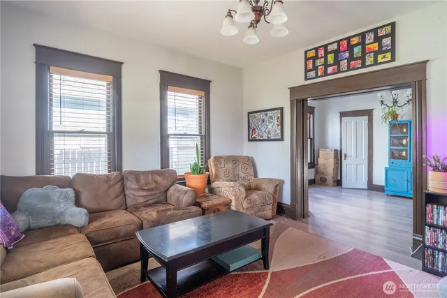 a living room with furniture a chandelier and a window