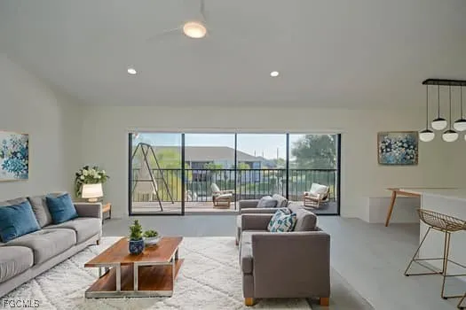 a living room with furniture and a floor to ceiling window