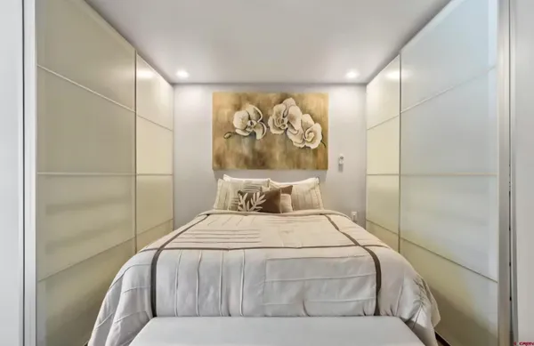 a bedroom with a large bed and a shower