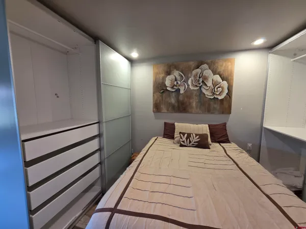 a view of a bedroom with wooden floor