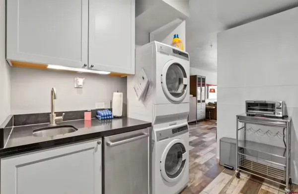 a kitchen with kitchen island a stove top oven sink and cabinets