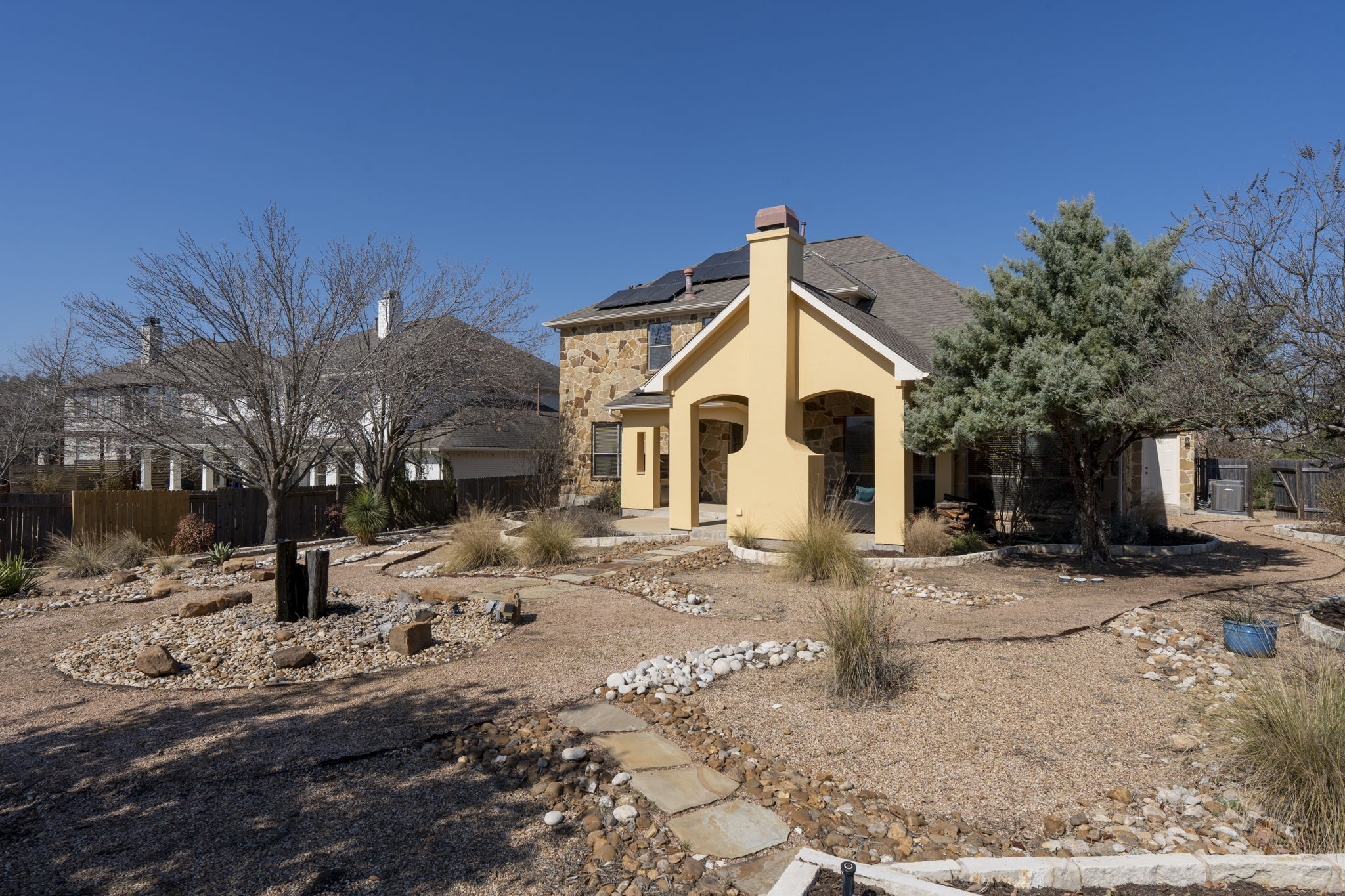 7809 Tusman Drive Austin, TX 78735 - Photo 2 of 38 a view of a white house with a yard covered in snow