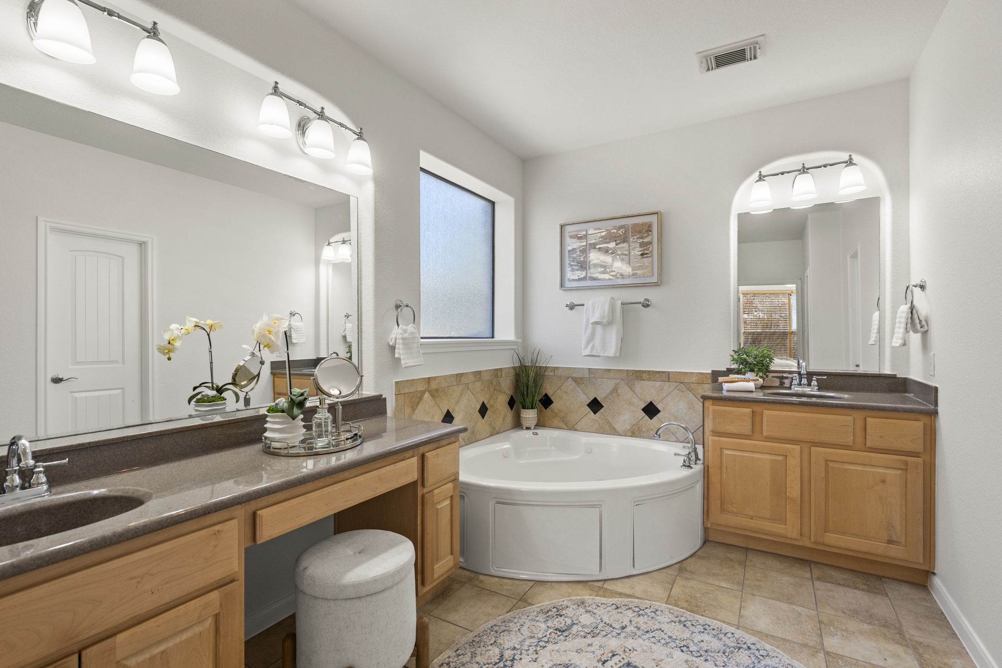 7809 Tusman Drive Austin, TX 78735 - Photo 21 of 38 a bathroom with a double vanity sink a mirror and a bathtub