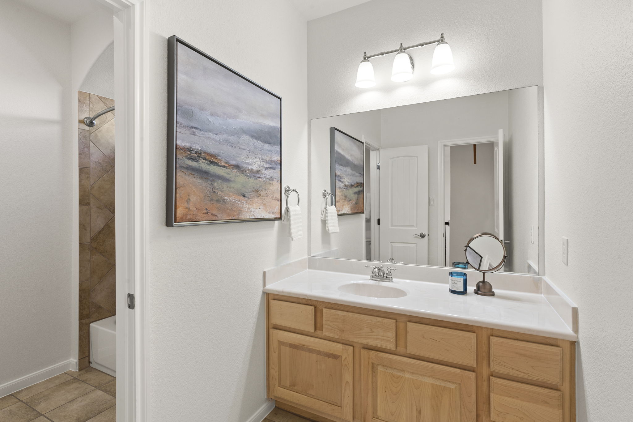 7809 Tusman Drive Austin, TX 78735 - Photo 30 of 38 a bathroom with a double vanity sink and a mirror