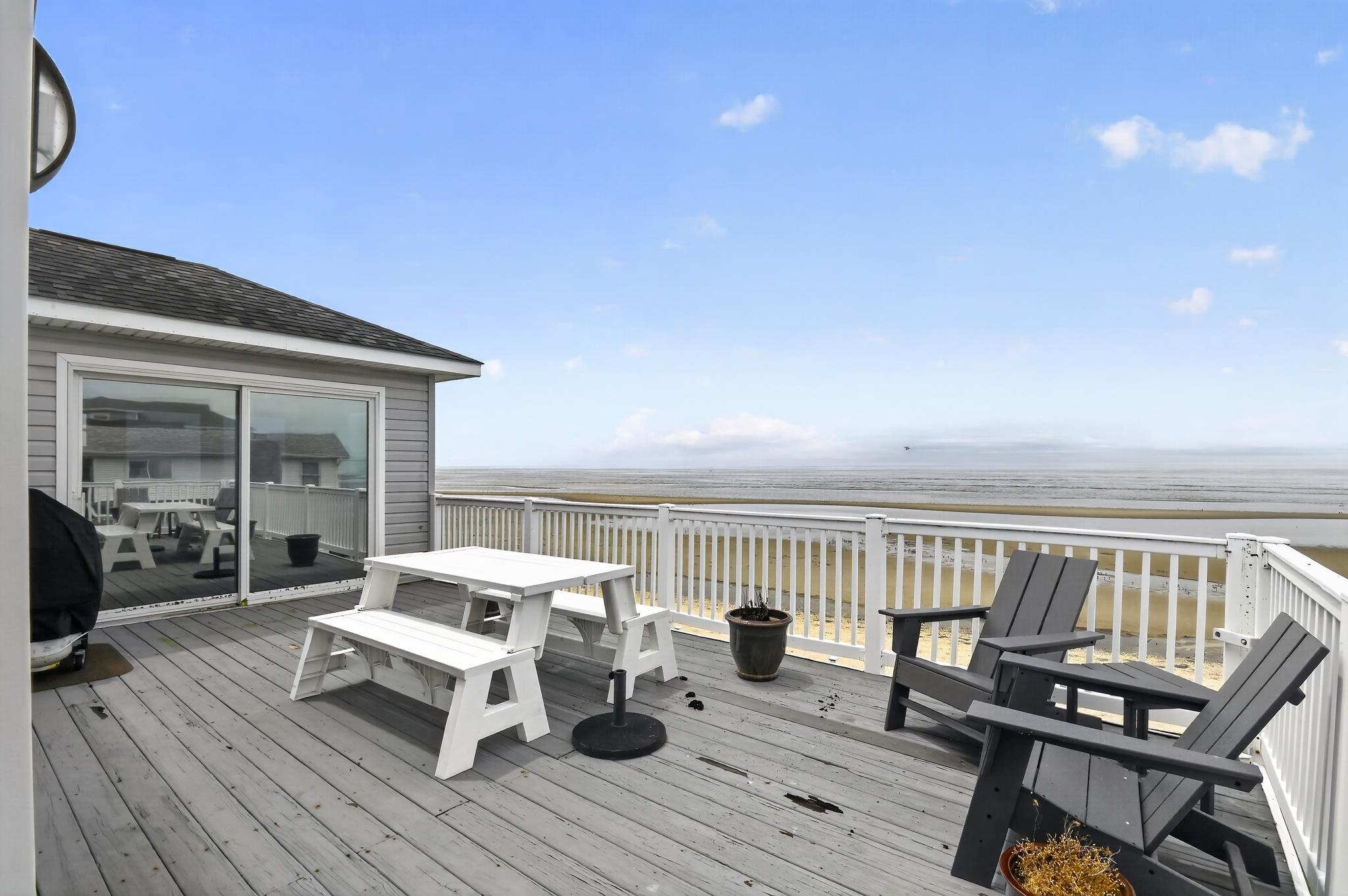 6 Pierces Point Road Cape May Court House, NJ 08210 - Photo 26 of 30 a roof deck with table and chairs and wooden floor