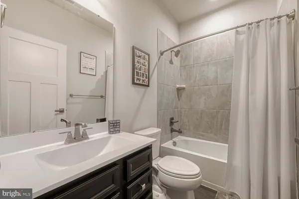 a bathroom with a sink a toilet and a bathtub