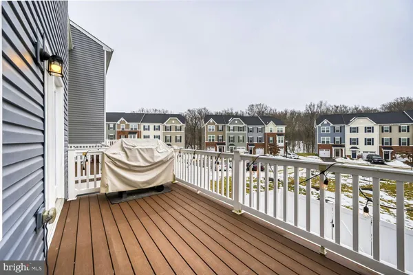 a view of a roof deck with wooden floor and fence