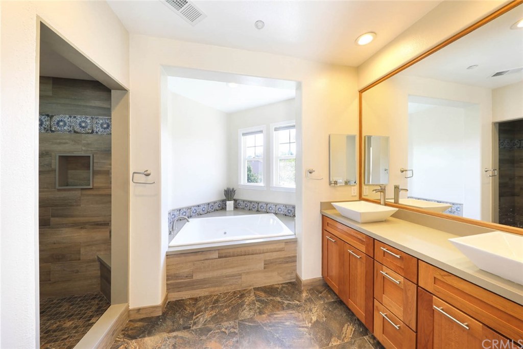 22 Calle Clasico San Clemente, CA 92673 - Photo 21 of 48 a spacious bathroom with a tub sink and mirror