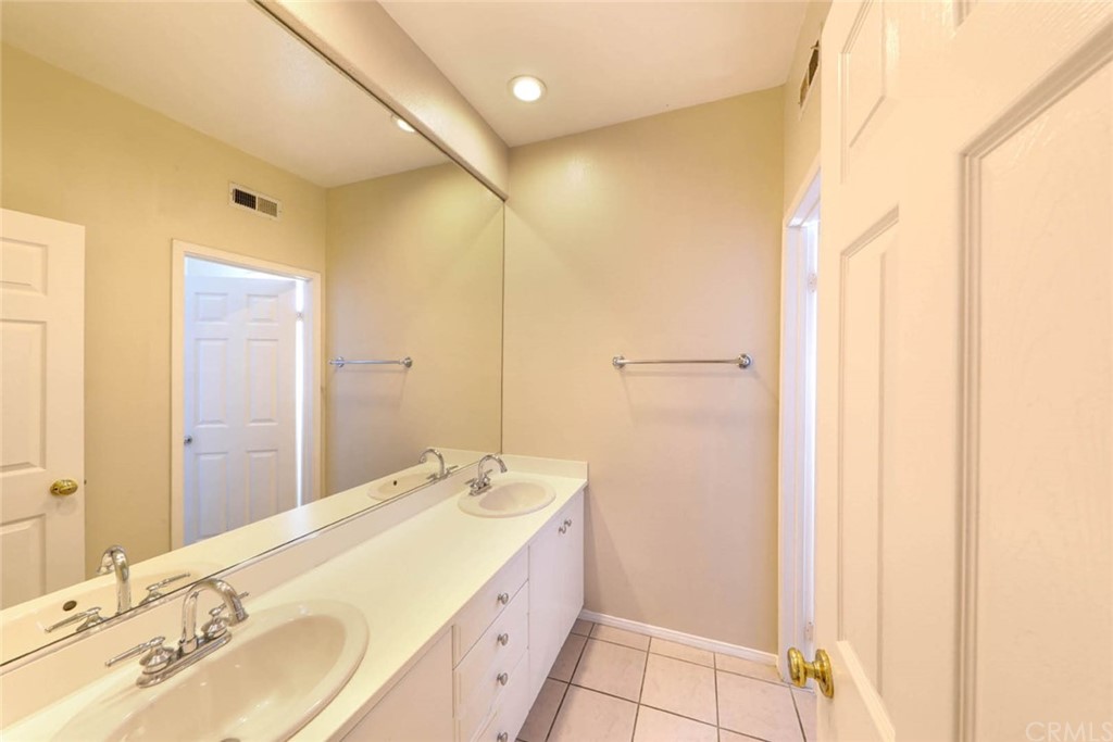22 Calle Clasico San Clemente, CA 92673 - Photo 25 of 48 a bathroom with a double vanity sink and a mirror