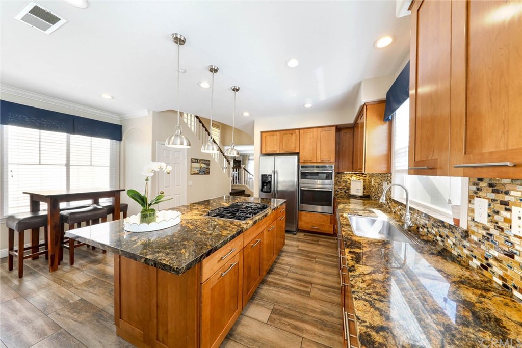 22 Calle Clasico San Clemente, CA 92673 - Photo 10 of 48 a kitchen with stainless steel appliances granite countertop a sink stove and cabinets