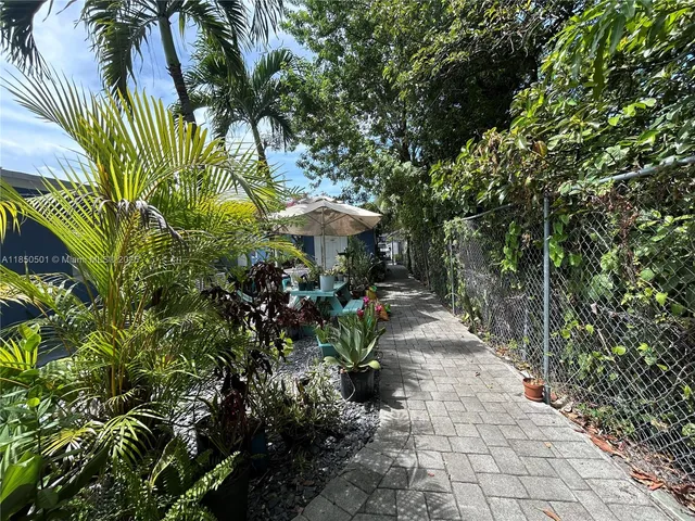 a view of a back yard with plants and a trees