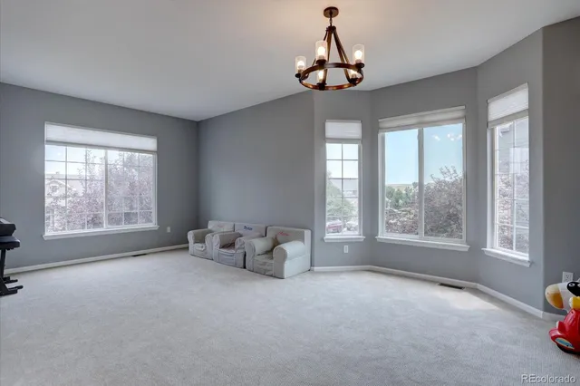 a living room with furniture and a chandelier