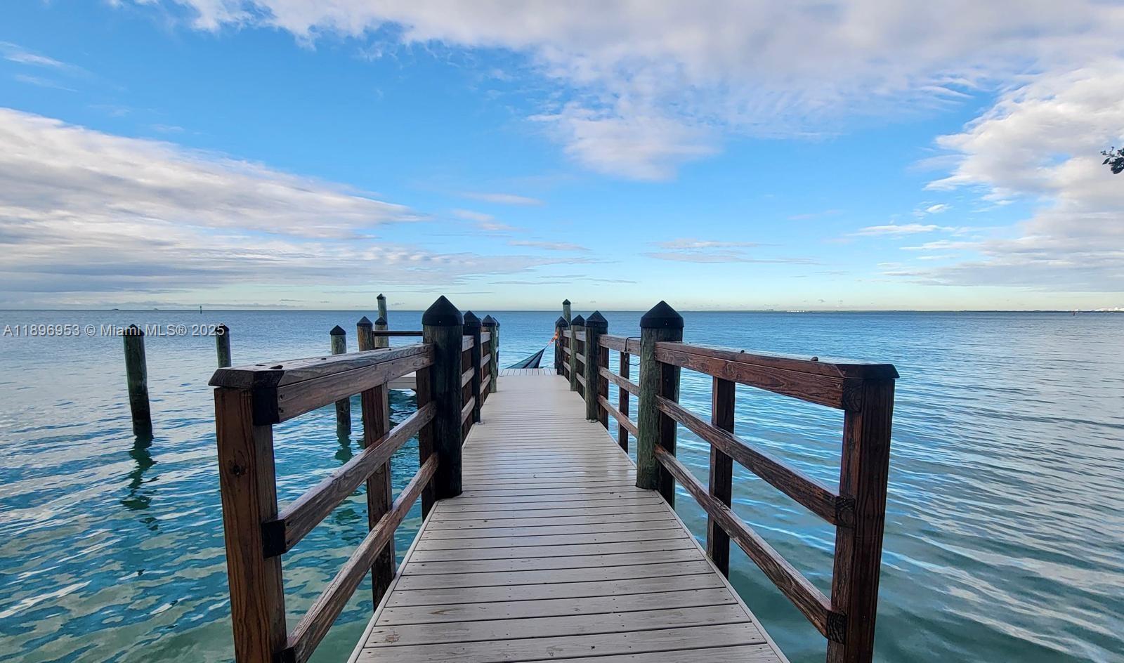 a view of a balcony with wooden floor and outdoor seating