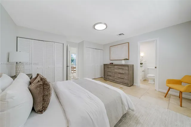 a bed room with a bed and a chair