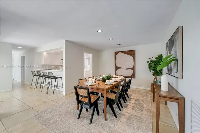 a view of a dining room with furniture and a potted plant