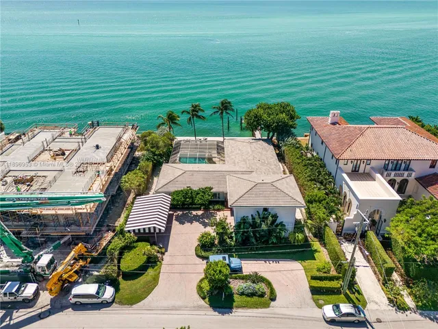 an aerial view of a house with outdoor space patio and trees all around