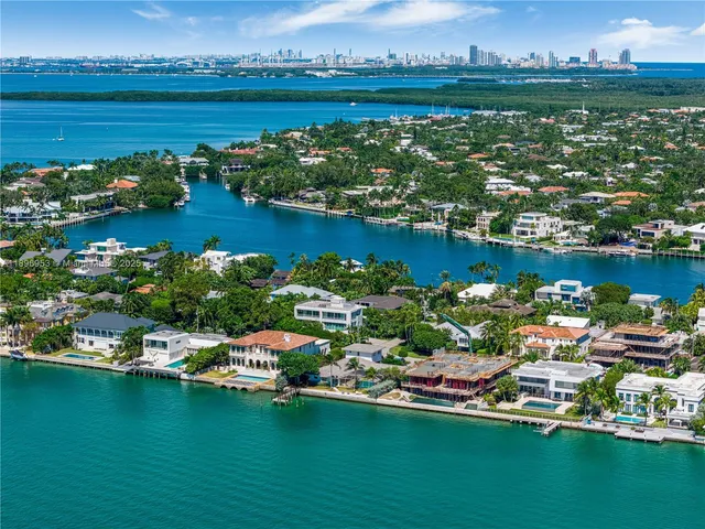an aerial view of a houses with a lake