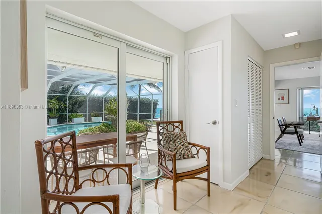 a dining room with furniture and large windows