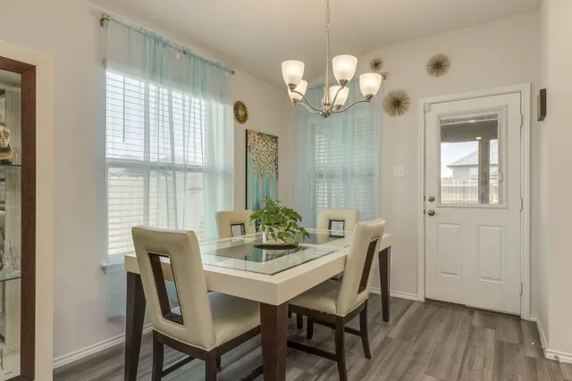 a view of a dining room with furniture wooden floor and chandelier