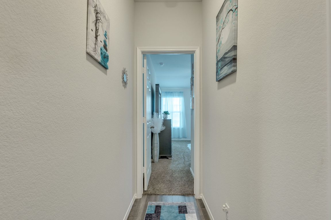 8932 Ranger Smt Road Temple, TX 76502 - Photo 23 of 40 a view of a hallway with wooden floor and a bathroom