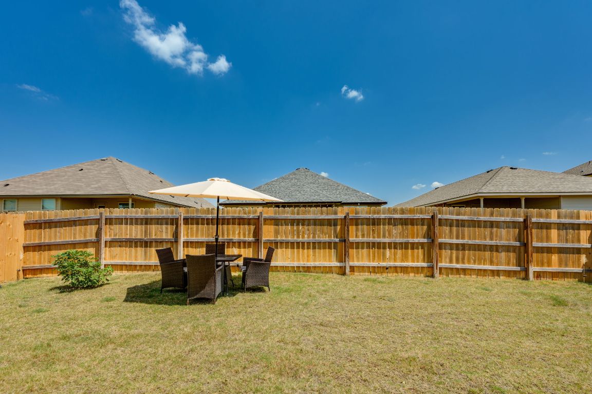 8932 Ranger Smt Road Temple, TX 76502 - Photo 37 of 40 a view of a patio with table and chairs under an umbrella