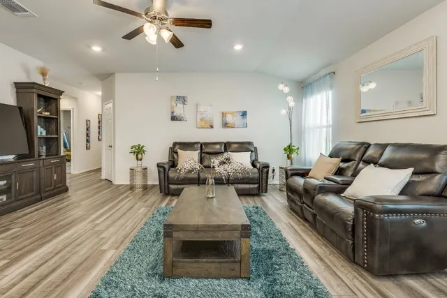 a living room with furniture and a flat screen tv