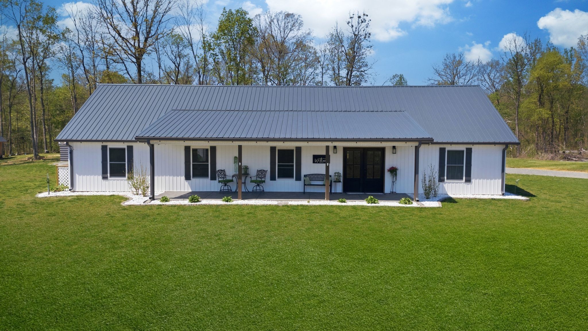 1043 Murphy Hollow Road Vanleer, TN 37181 - Photo 54 of 68 a front view of a house with a garden and porch