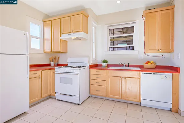 a kitchen with cabinets appliances and a window