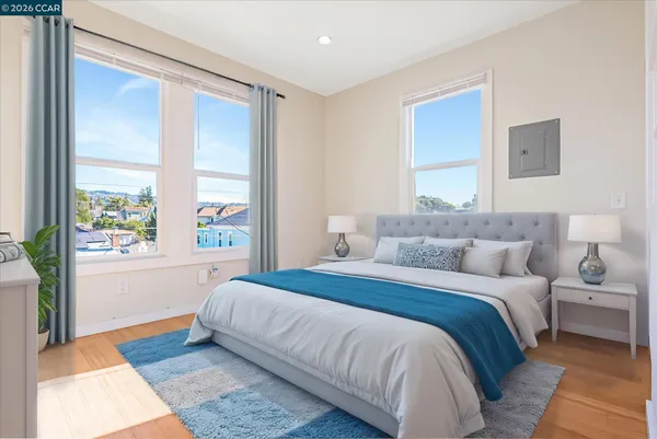 a bedroom with a large bed and a large window
