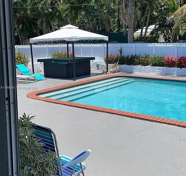 1319 Fillmore Street Hollywood, FL 33019 - Photo 2 of 12 a front view of a house with garden