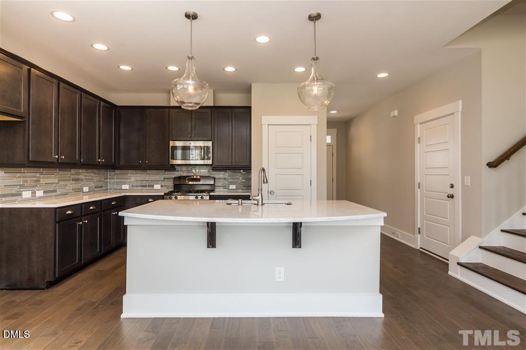 14 Tarwick Avenue Chapel Hill, NC 27516 - Photo 11 of 47 a kitchen with kitchen island granite countertop a sink appliances and cabinets