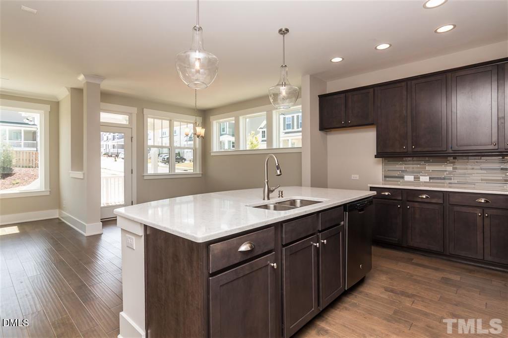 14 Tarwick Avenue Chapel Hill, NC 27516 - Photo 14 of 47 a kitchen with a sink chandelier and wooden floor