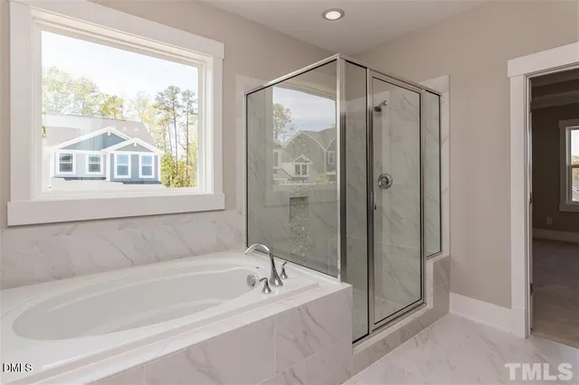 a spacious bathroom with a bathtub and a shower