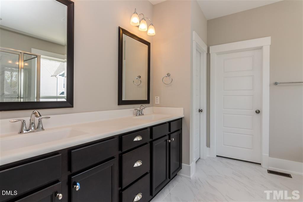 14 Tarwick Avenue Chapel Hill, NC 27516 - Photo 23 of 47 a bathroom with a double vanity sink and mirror