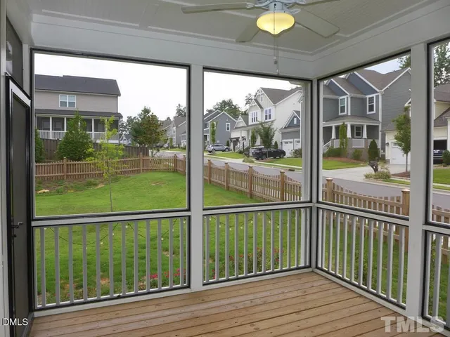 a view of a wooden deck next to a yard