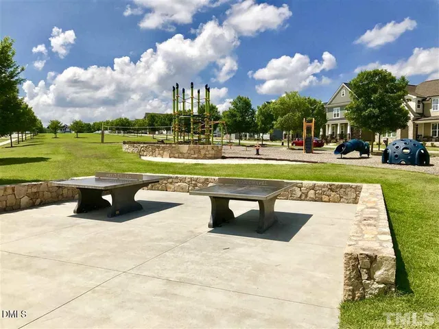 a view of a swimming pool and outdoor seating
