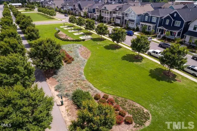 an aerial view of a house with a garden and lake view