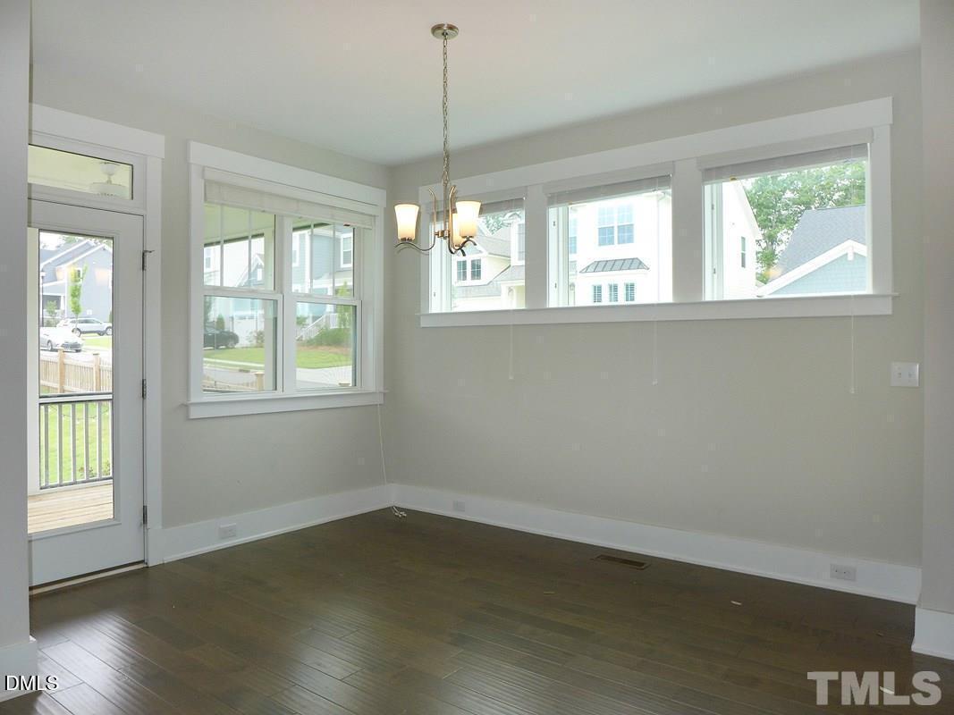 14 Tarwick Avenue Chapel Hill, NC 27516 - Photo 6 of 47 a view of an empty room with wooden floor and a window