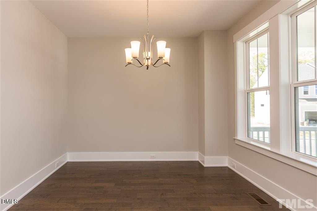 14 Tarwick Avenue Chapel Hill, NC 27516 - Photo 9 of 47 an empty room with wooden floor and windows