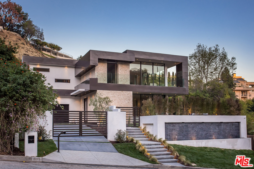1424 Rising Glen Road Los Angeles, CA 90069 - Photo 23 of 48 a front view of a house with a garden