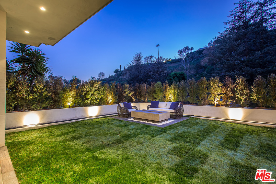 1424 Rising Glen Road Los Angeles, CA 90069 - Photo 25 of 48 a view of a swimming pool and lounge chairs