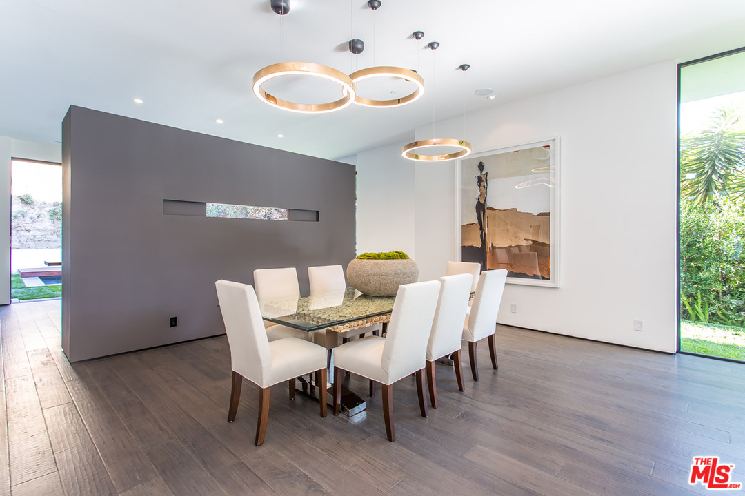 1424 Rising Glen Road Los Angeles, CA 90069 - Photo 26 of 48 a view of a dining room with furniture and wooden floor