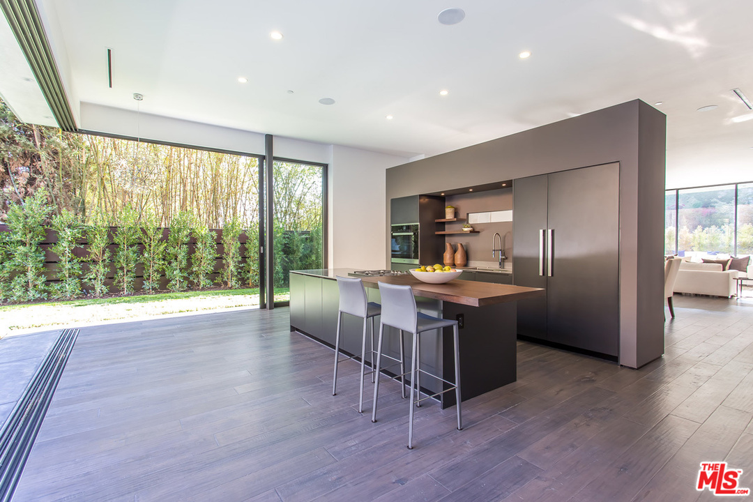 1424 Rising Glen Road Los Angeles, CA 90069 - Photo 31 of 48 a large kitchen with a table and chairs