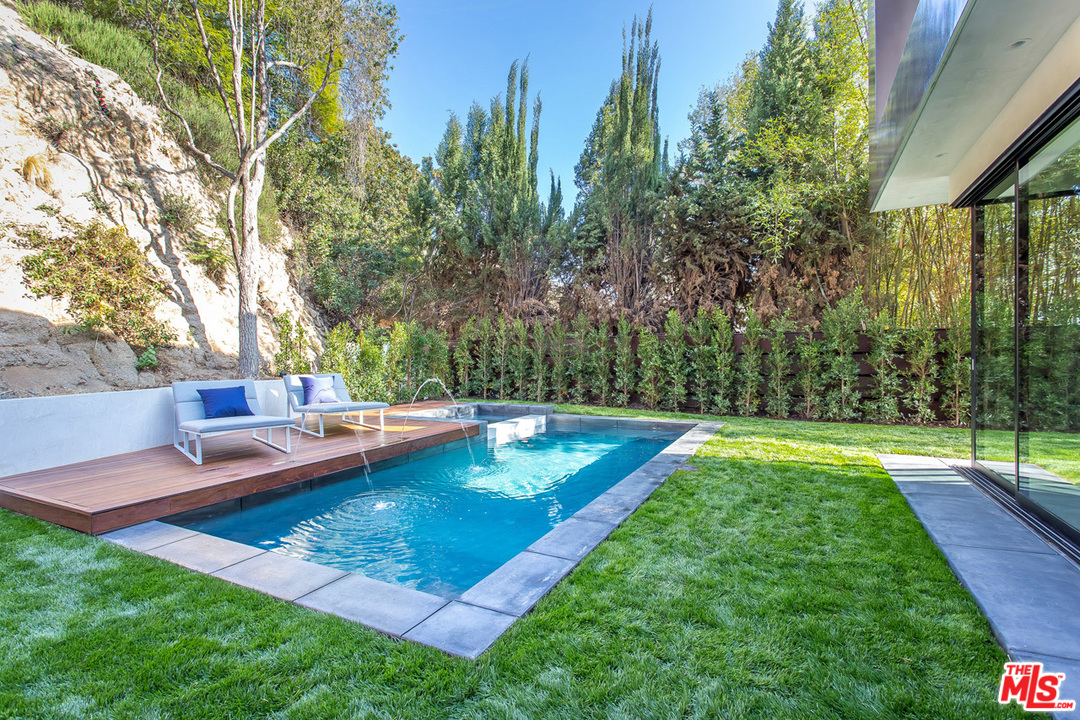1424 Rising Glen Road Los Angeles, CA 90069 - Photo 32 of 48 a view of a backyard with swimming pool