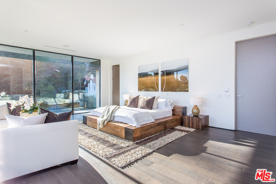 1424 Rising Glen Road Los Angeles, CA 90069 - Photo 36 of 48 a living room with furniture and a floor to ceiling window
