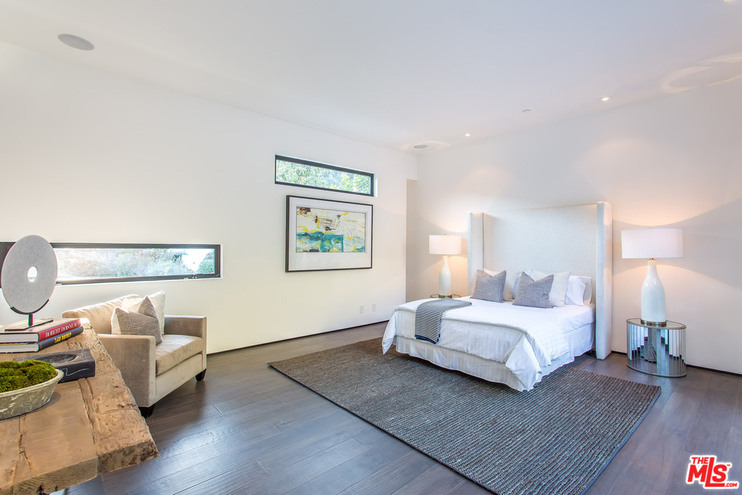 1424 Rising Glen Road Los Angeles, CA 90069 - Photo 38 of 48 a bedroom with a bed and wooden floor
